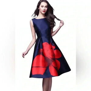 Wyky This dress is by the designer WYQY It's a navy blue midi red floral.